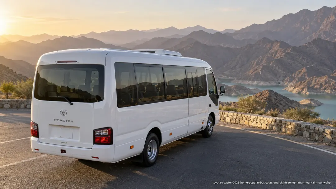Illustrative Toyota Coaster bus for a private group sightseeing journey toward Hatta mountain attractions